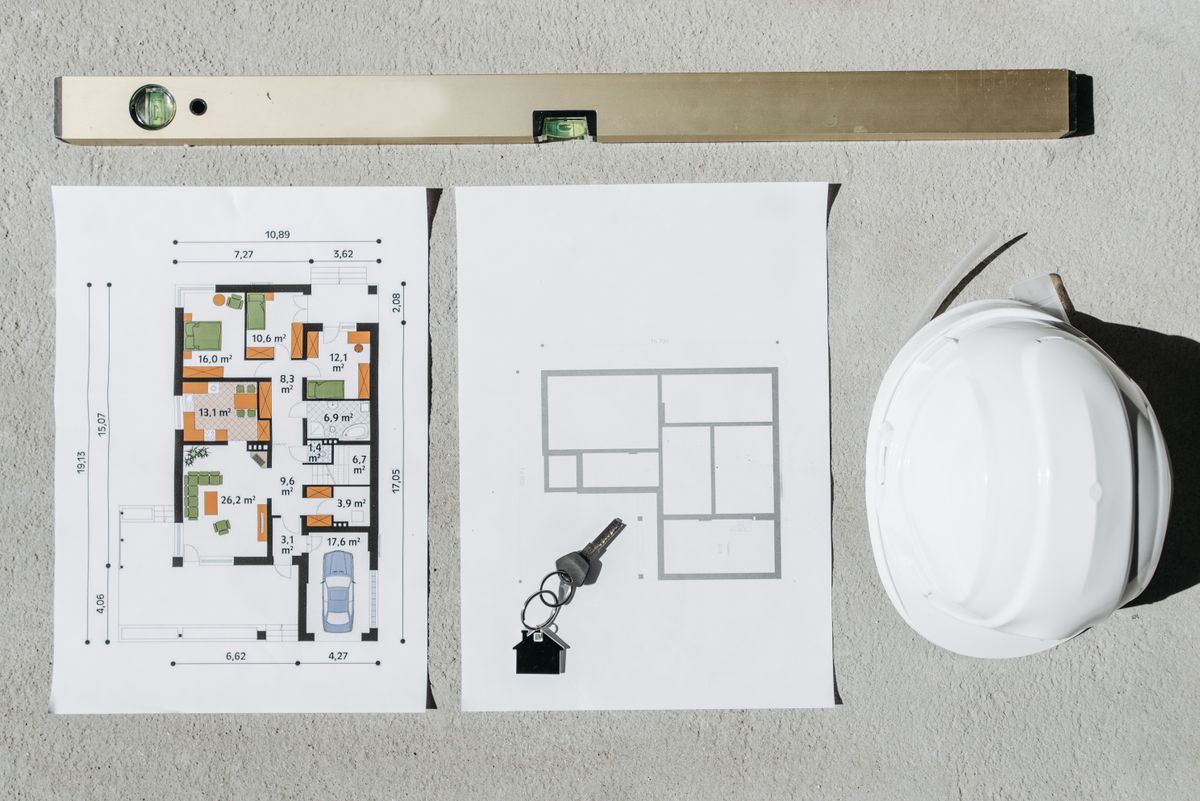 Construction planning: blueprints, level and hard hat
